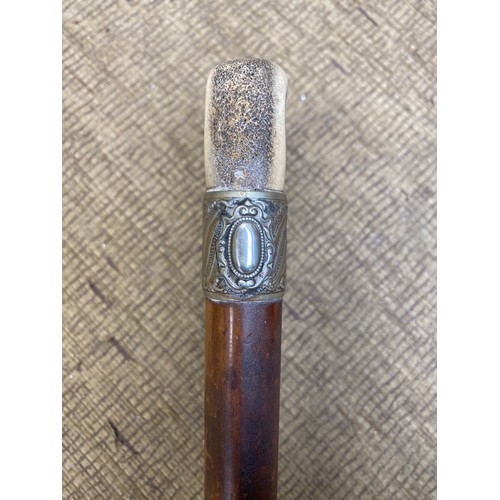 678 - Vintage walking cane with deer antler handle and white metal band.