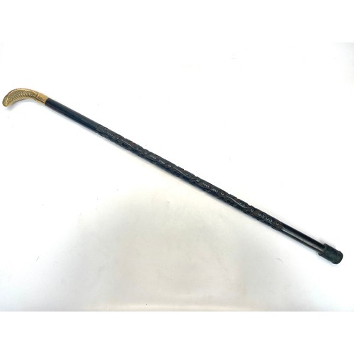 718 - Cobra head handle ebonized hand craved walking cane.