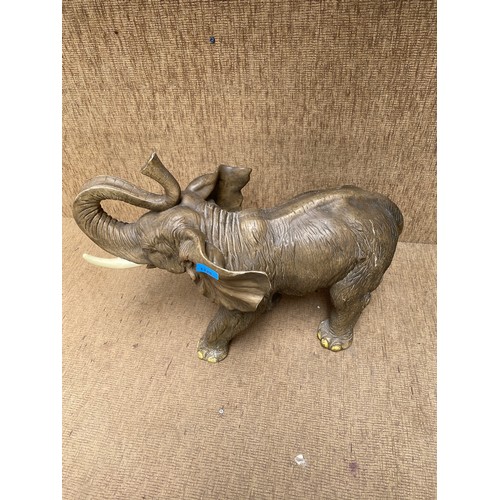 1125 - a large resin elephant 48cm high one tusk slightly damaged