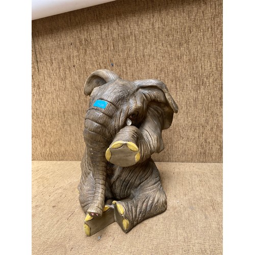 1126 - A large resin sitting elephant