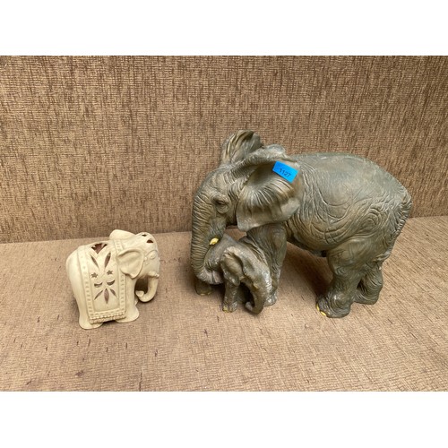 1127 - A large resin elephant mother and baby 33cm high and a smaller ceramic one