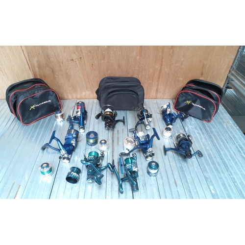 594 - A collection of 9 fishing reels with spare spools and come cases