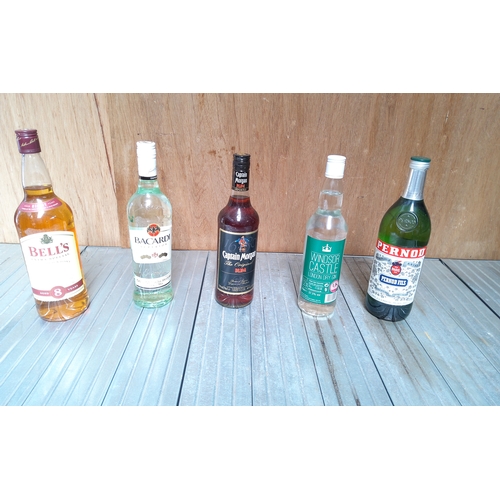 195 - Five bottles of alcohol including bacardi,whiskey,pernod,captain Morgan and gin