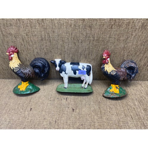 502 - Pair of cockerel cast iron door stops and a cow door stop.