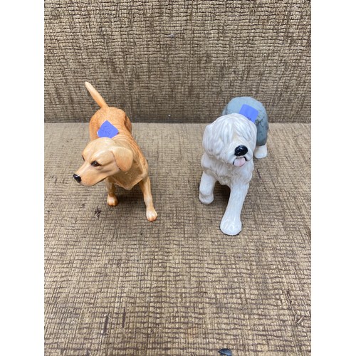 564 - Two Royal Doulton dogs, a Labrador retriever and a old English sheep dog. 14cm tall.