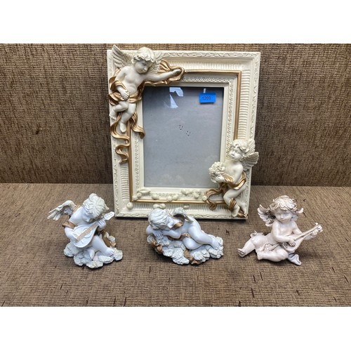 1200 - Large cherub frame and 3 cherub figures.