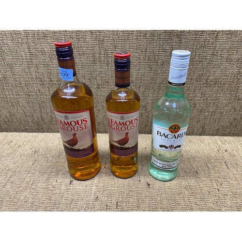 1077 - two bottles of famous grouse and Bacardi.