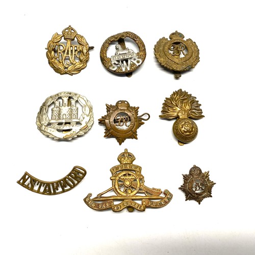 725 - 9 WWI cap badges and badges.