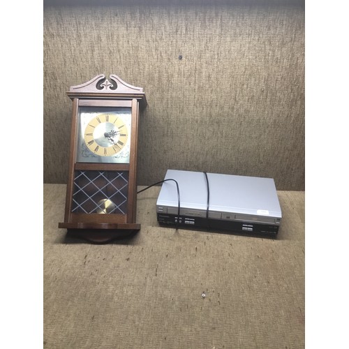 192 - Panasonic NV-VP33 DVD/VHS player and a wall clock