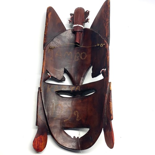 799 - Hand carved wooden maasai tribe mask, Jambo spears and a Machu Picchu rain stick.