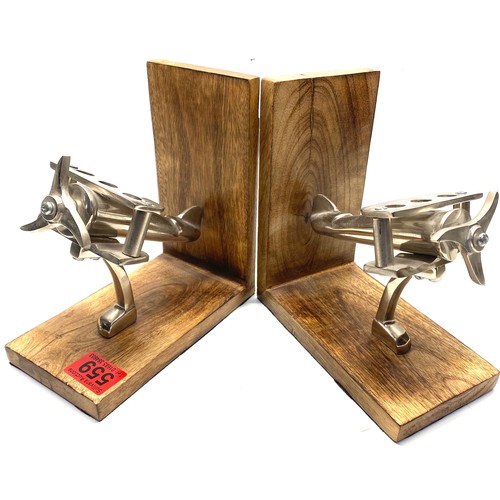 559 - Pair of arts and crafts metal aeroplane on a wooden base bookends.