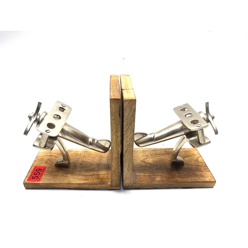 559 - Pair of arts and crafts metal aeroplane on a wooden base bookends.