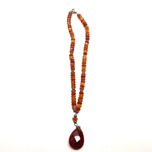 720 - Carnelian and silver necklace, silver Marcasite mourning brooch and Amethyst pendant.