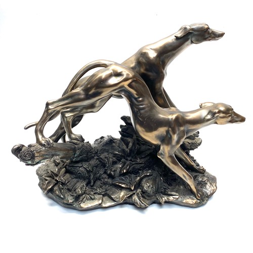 569 - Large bronzed greyhound figures; 65cm.