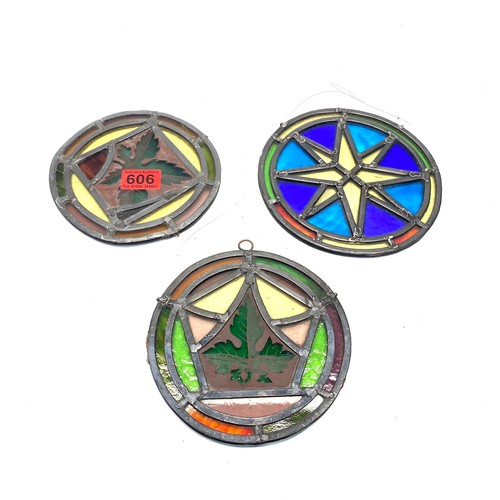 606 - three stained glass hanging pieces from a church