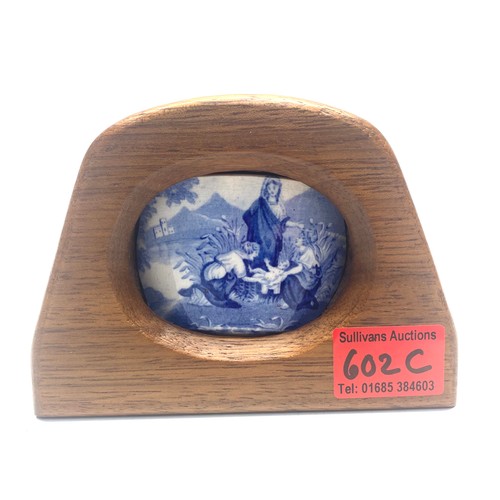 602C - Interesting Swansea pottery plaque encased in a homemade wooden stand, depicting the birth of a chil... 