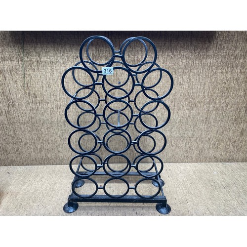 316 - Cast iron wine rack.