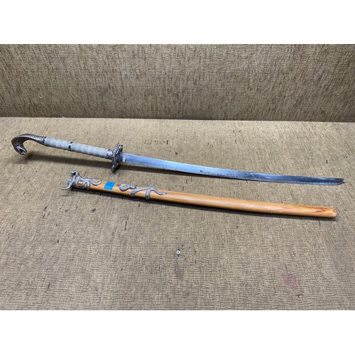 1020 - Serpent hilted sword with wooden sheath. (18+ local collection only).