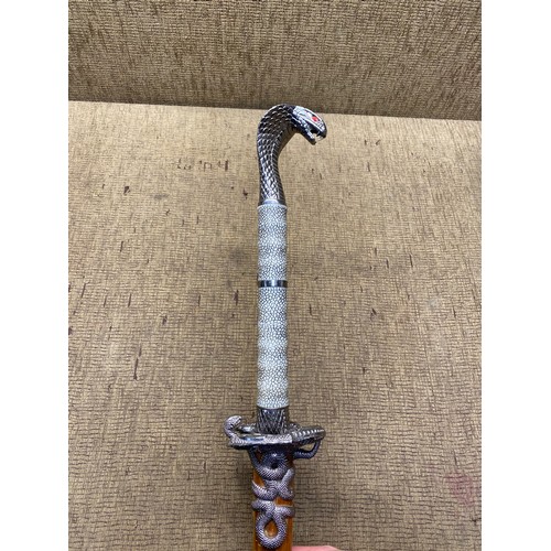 1020 - Serpent hilted sword with wooden sheath. (18+ local collection only).