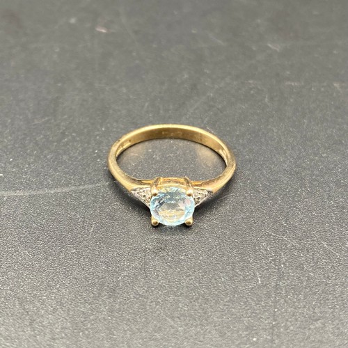 809 - 9ct gold ring with Aqua marine stone and diamond shoulders. Size N. 2.1g.