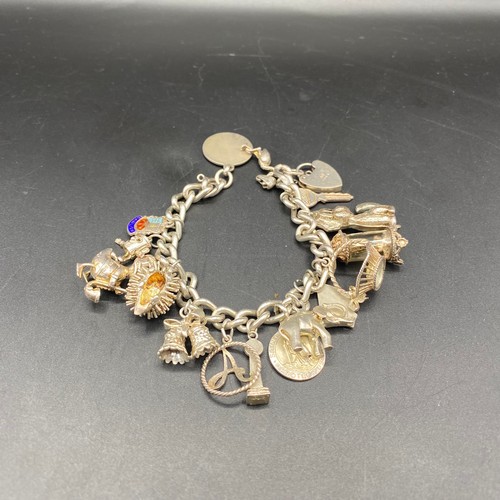 818 - Sterling silver charm bracelet and 16 charms.