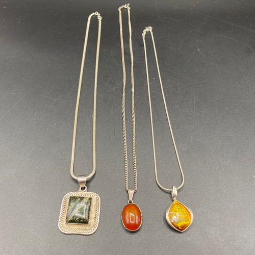 829 - Three silver necklaces and pendants, including an antique carnelian pendant Mexican Tulum and handma... 