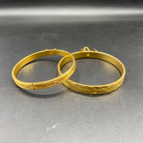 712 - Two 18ct rolled gold plate bangles.