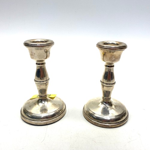 858 - Pair of sterling silver candlesticks. Hallmarks for Birmingham 1955 (damage to stem of one).