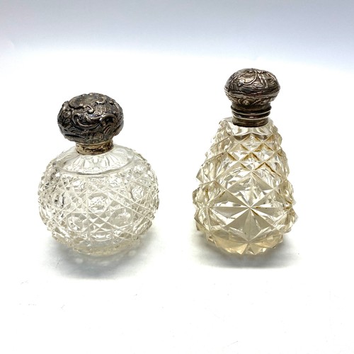 726 - Two silver topped cut crystal perfume bottles, round bottle Birmingham 1907 and the other Birmingham... 