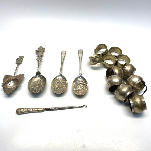 730 - Two sets of silver plate napkin rings, ornate Asian tea strainer, button hook, Dutch serving spoon a... 