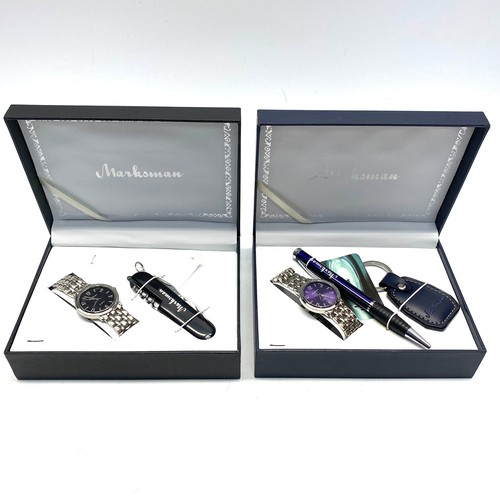 879 - Two marksman boxed watches with pens and keyrings.