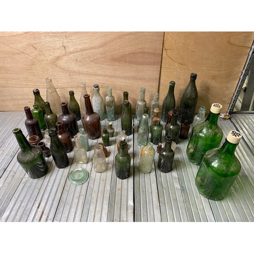 135 - A selection of old glass bottles mainly local breweries including Porth, Pontypridd and Rhymney