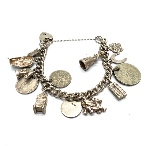 900 - Silver charm bracelet and charms.