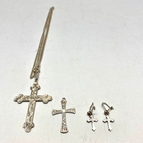 910 - Large silver cross and chain, smaller cross and earrings.