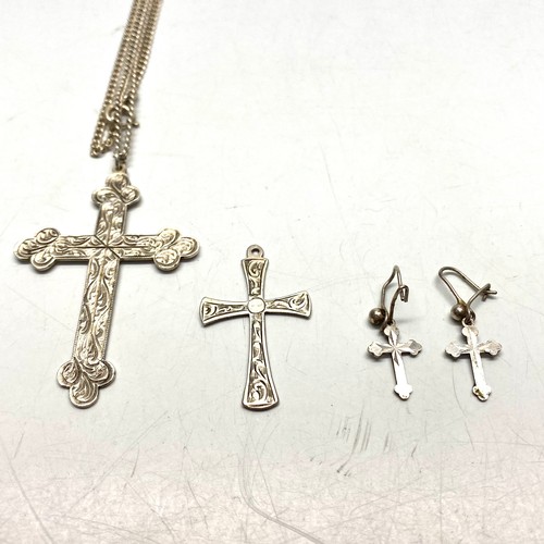 910 - Large silver cross and chain, smaller cross and earrings.