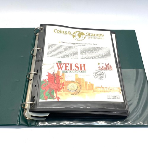 935 - Large collection of world coins and first day covers in a folder.