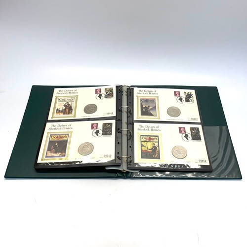 935 - Large collection of world coins and first day covers in a folder.