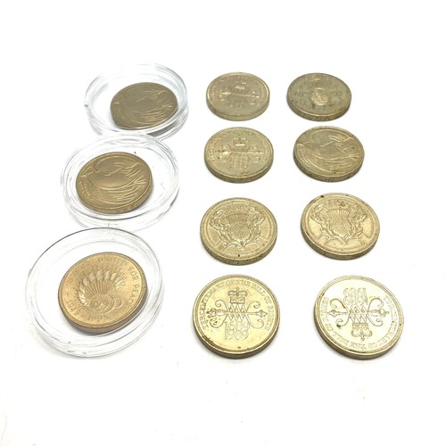 950 - 11 collectible £2 coins in a money box with key.