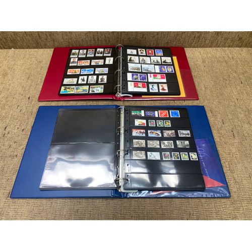 792 - One Red and one Blue deluxe stamp albums containing stamps from Norway and China.