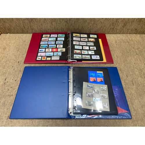 792 - One Red and one Blue deluxe stamp albums containing stamps from Norway and China.