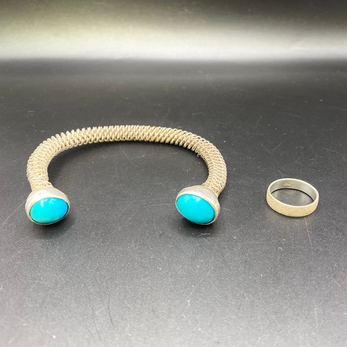 811 - Silver ring size O and a hand Spring bangle with turquoise stones. (possibly Egyptian NHMTAS).