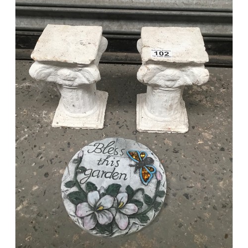 102 - Two small concrete pillars and a garden plaque