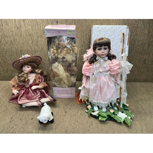 84 - 3 collectible porcelain dolls.