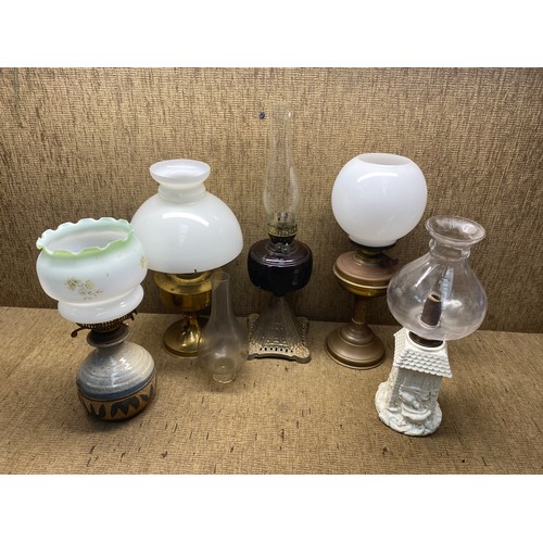 1100 - Selection of oil lamps and accessories.