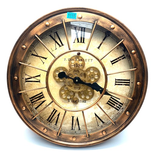 1115 - J.D Bassett 1922 Virginia moving gears wall clock copper wash 60cm.