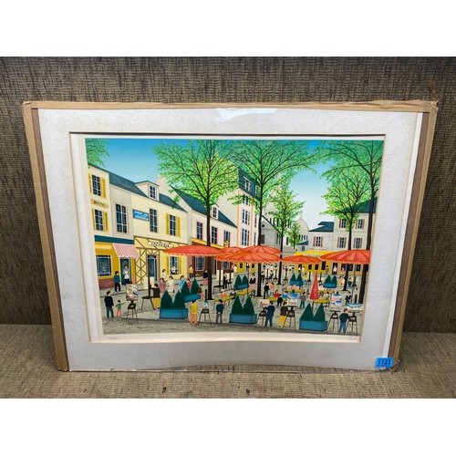 1123 - Framed print of a busy French street signed by artist.