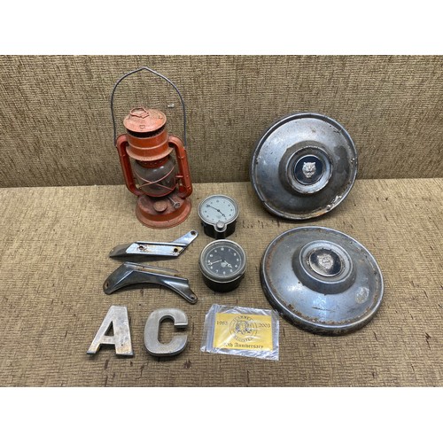 712 - Collectible items including: Oil lantern, Gauges and Jaguar rim covers.