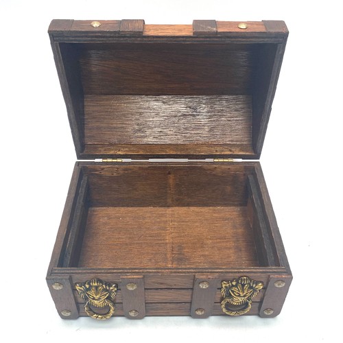 625 - Wooden treasure chest jewellery box with brass fittings; 18cm tall and 20cm wide.