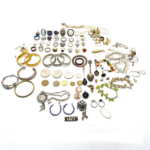 406 - Costume jewellery including a collection of dress rings, cufflinks and coins.