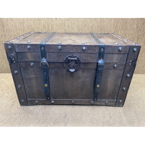 1043 - vintage wooden storage trunk with ironmongery and leather straps.